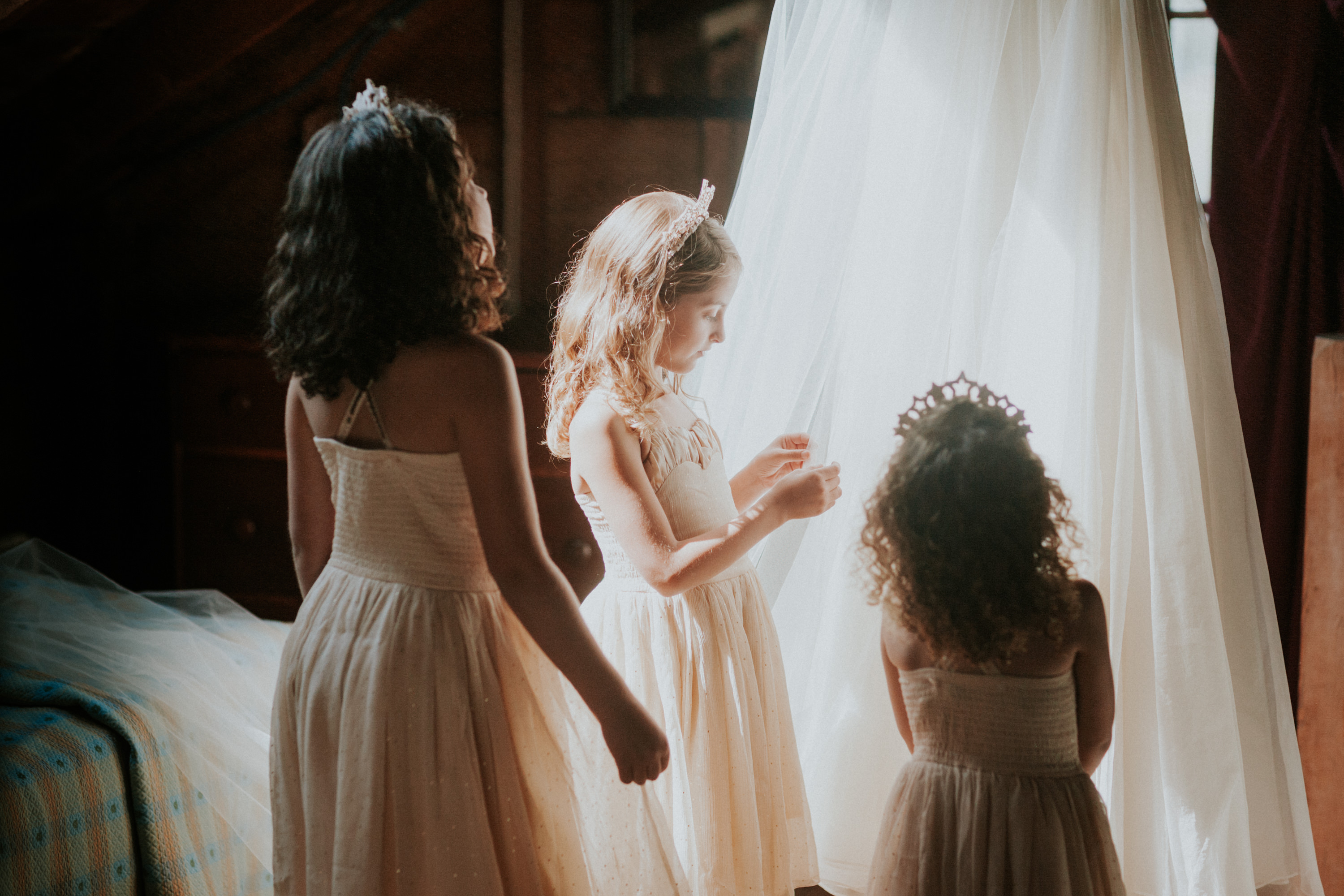 flower girls looking at wedding dress, flower girl touching wedding dress, leanne marshall dress hanging