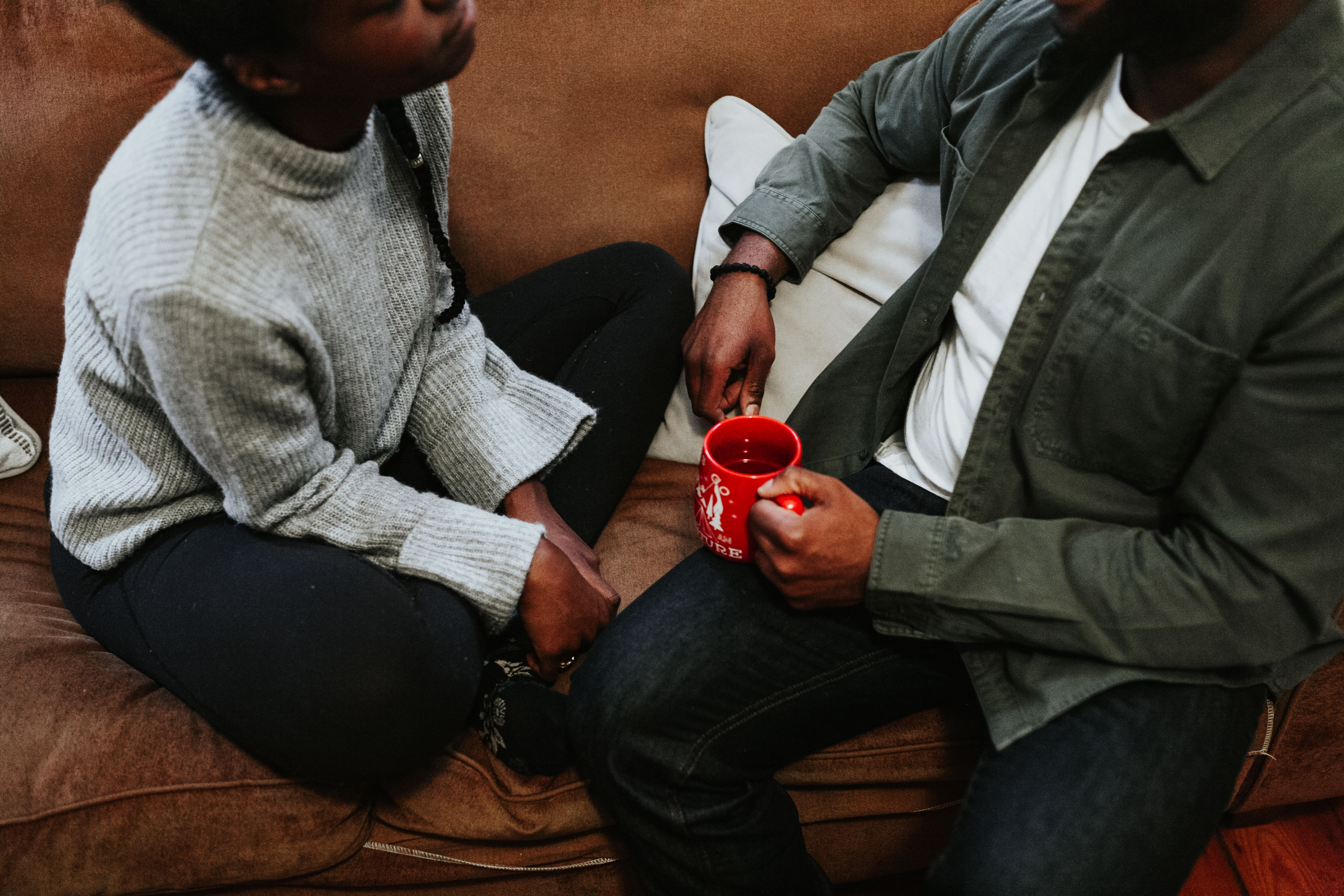 Cozy on couch, couple drinking tea on couch
