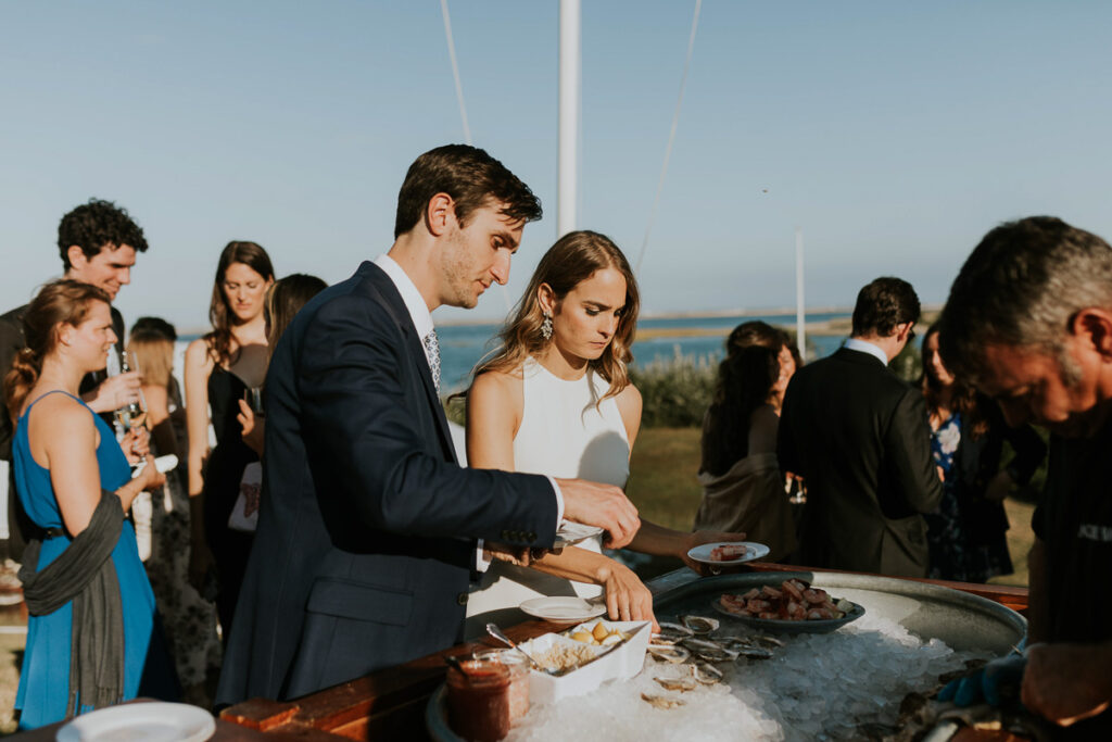 bride and groom enjoy oysters on the half shell during their after ceremony refreshments on Cape Cod
