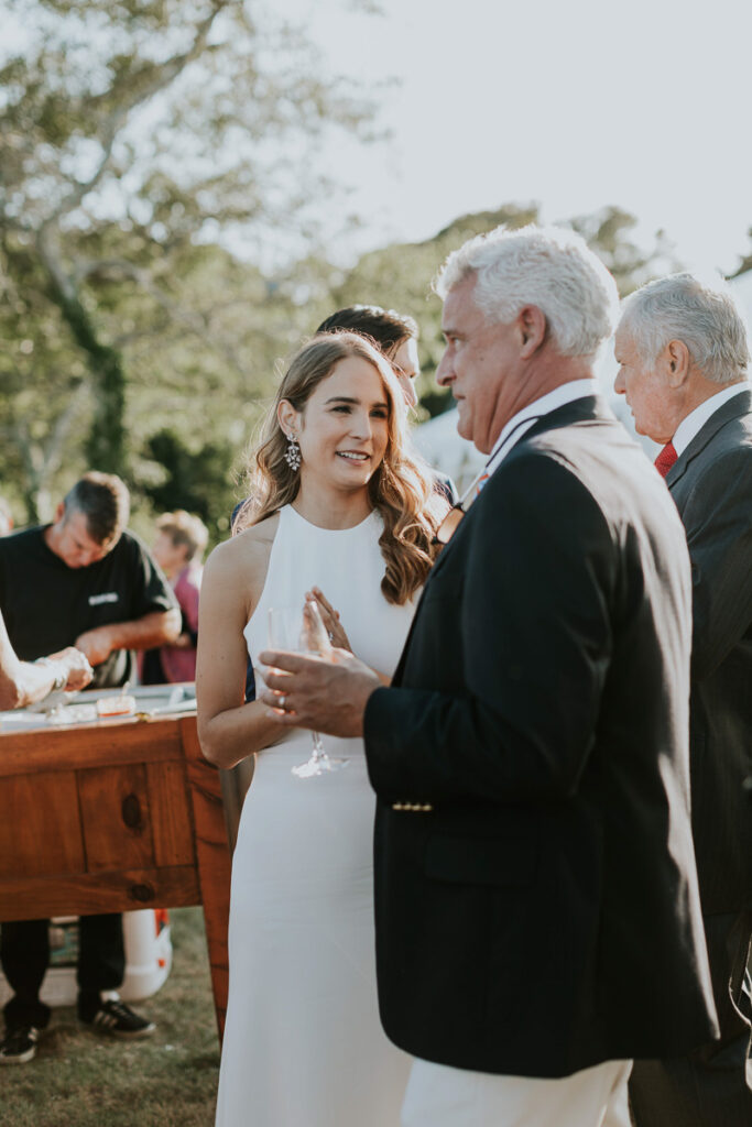 bride chats with her dad during outdoor Cape Cod wedding reception