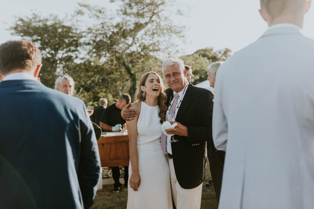 Father of the bride looks proud as he hugs his beautiful bride daughter