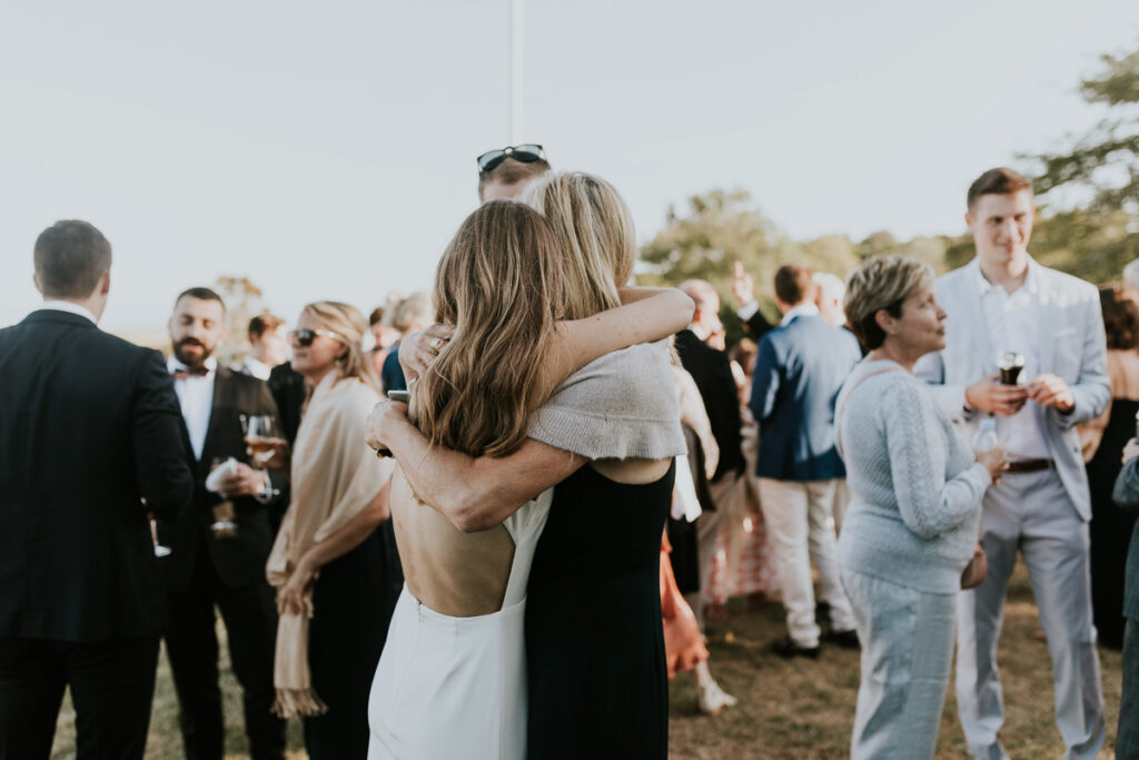 Bride hugs her mom after Cape Cod wedding ceremony