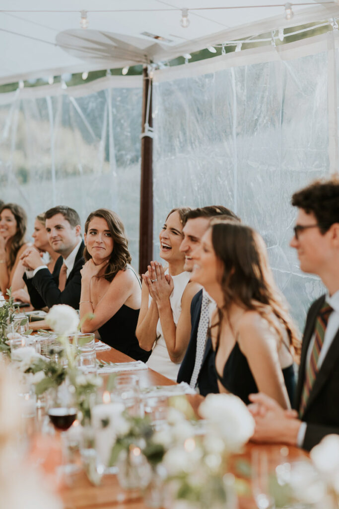 wedding party laughs at Mother of the Bride's speech during Cape Cod wedding reception