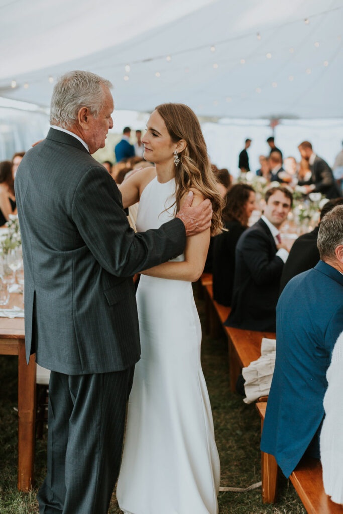 bride shares a happy moment with her father at a Cape Cod wedding reception