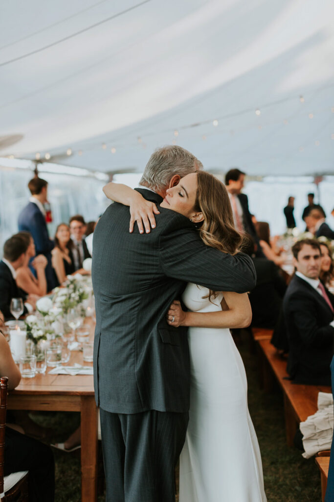 bride hugs her father after his speech at her Cape Cod wedding reception