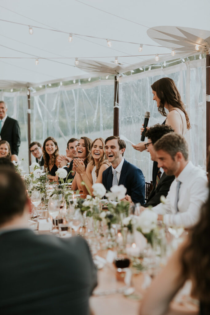 bridal party laughs at Best Woman's speech at a Cape Cod wedding