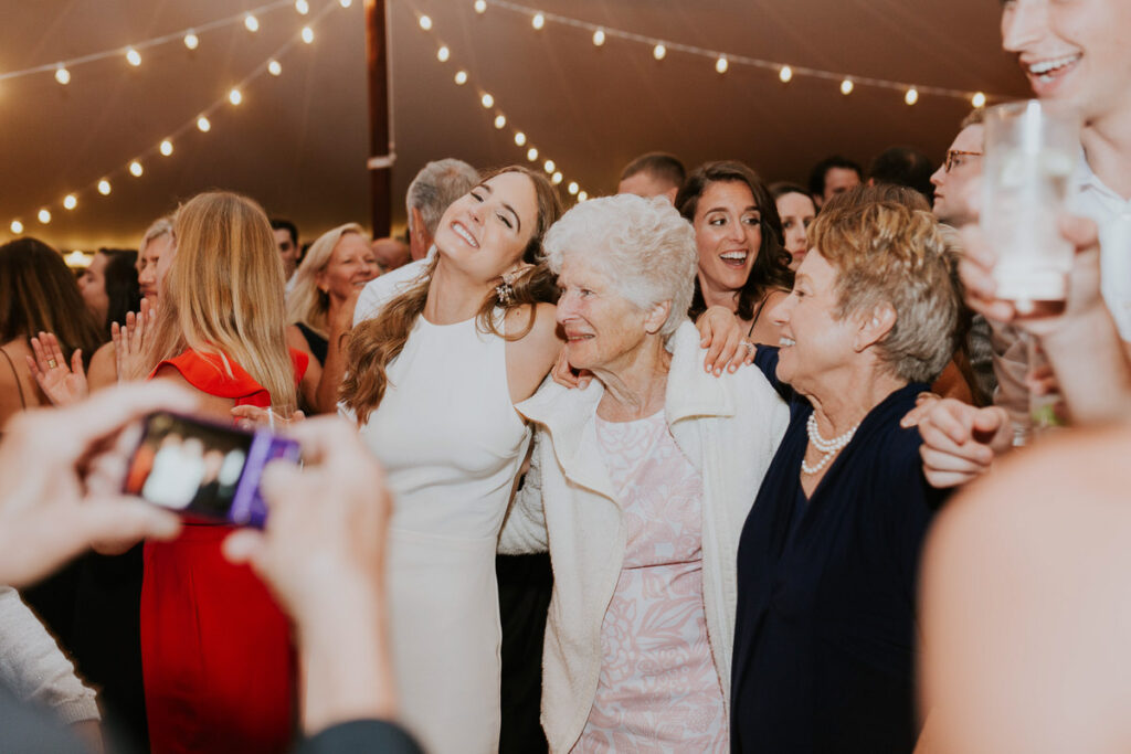 Cape Cod bride poses for a photo with her mom and grandma on the dance floor during her reception