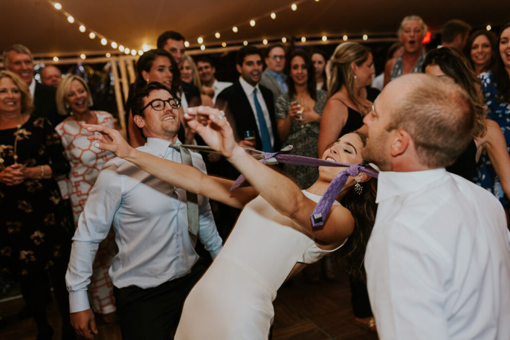 bride limbos under neckties at Cape Cod wedding reception