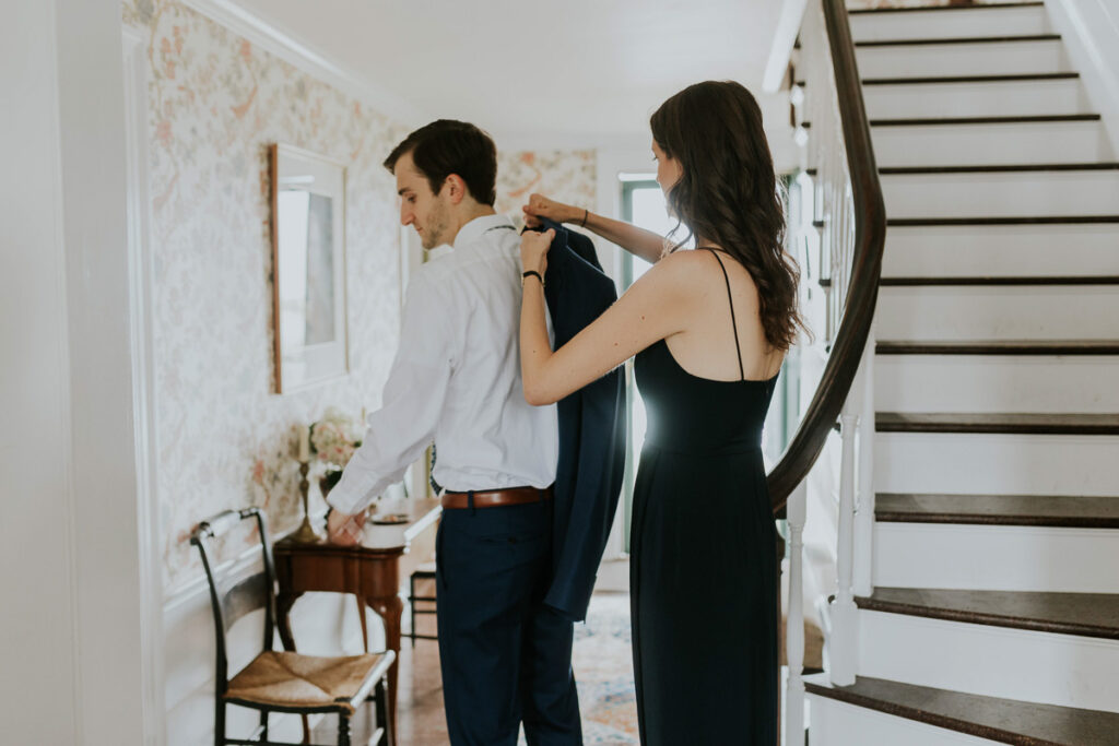 Best Woman helps groom get dressed on his wedding day