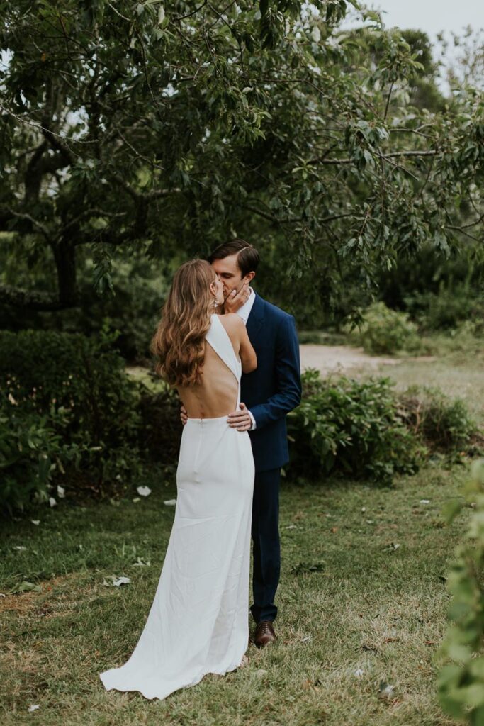 bride and groom kiss during first look on Cape Cod
