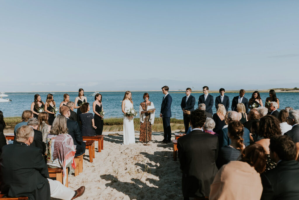 Image of seated guests and bridal party during beachfront Cape Cod wedding