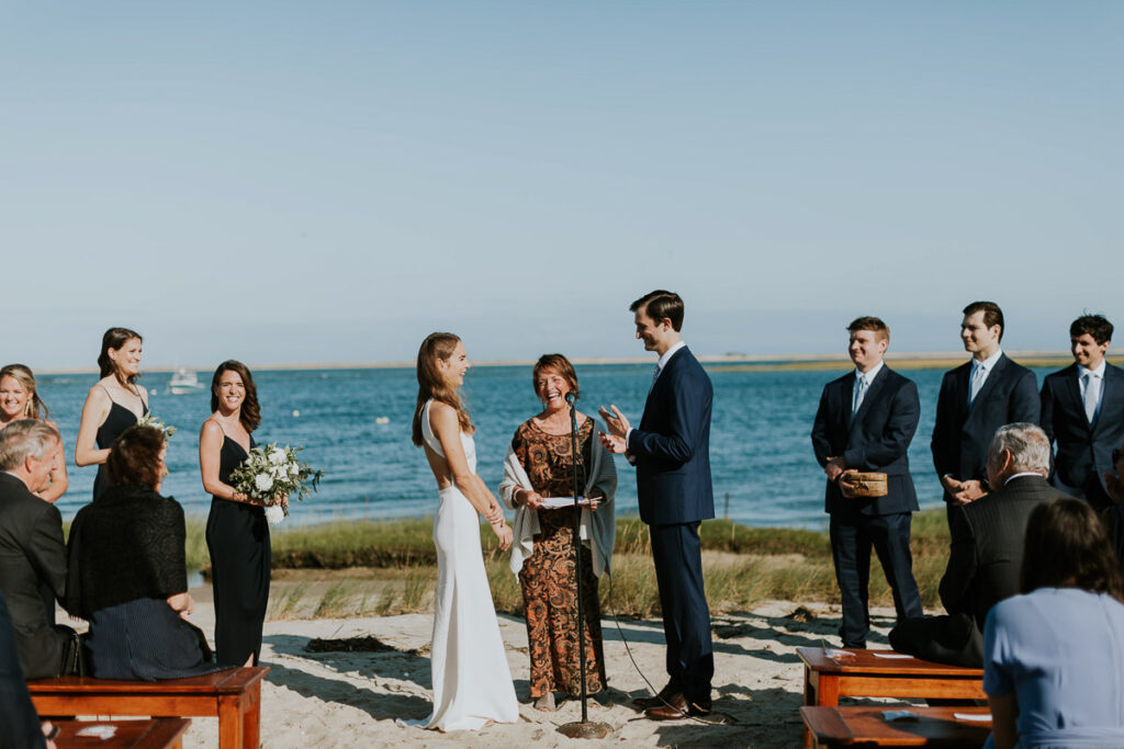 everyone laughing during a marriage ceremony on the beach in Cape Cod