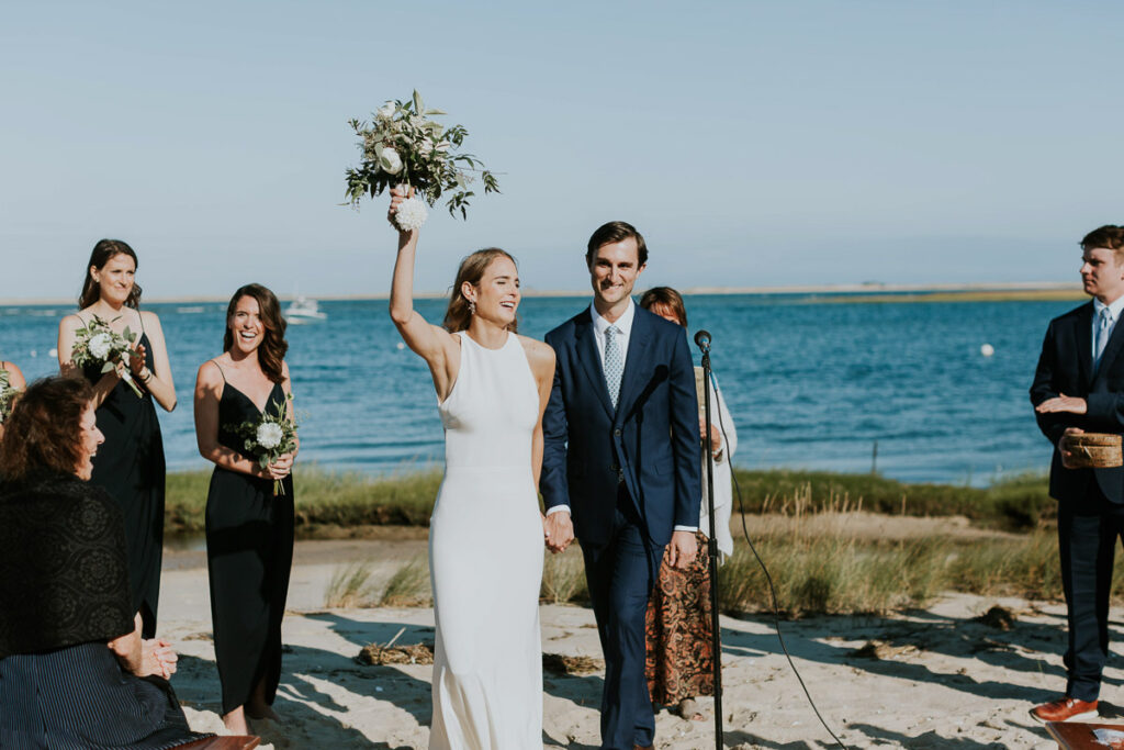 bride and groom celebrate and cheer after their first kiss in Cape Cod wedding ceremony